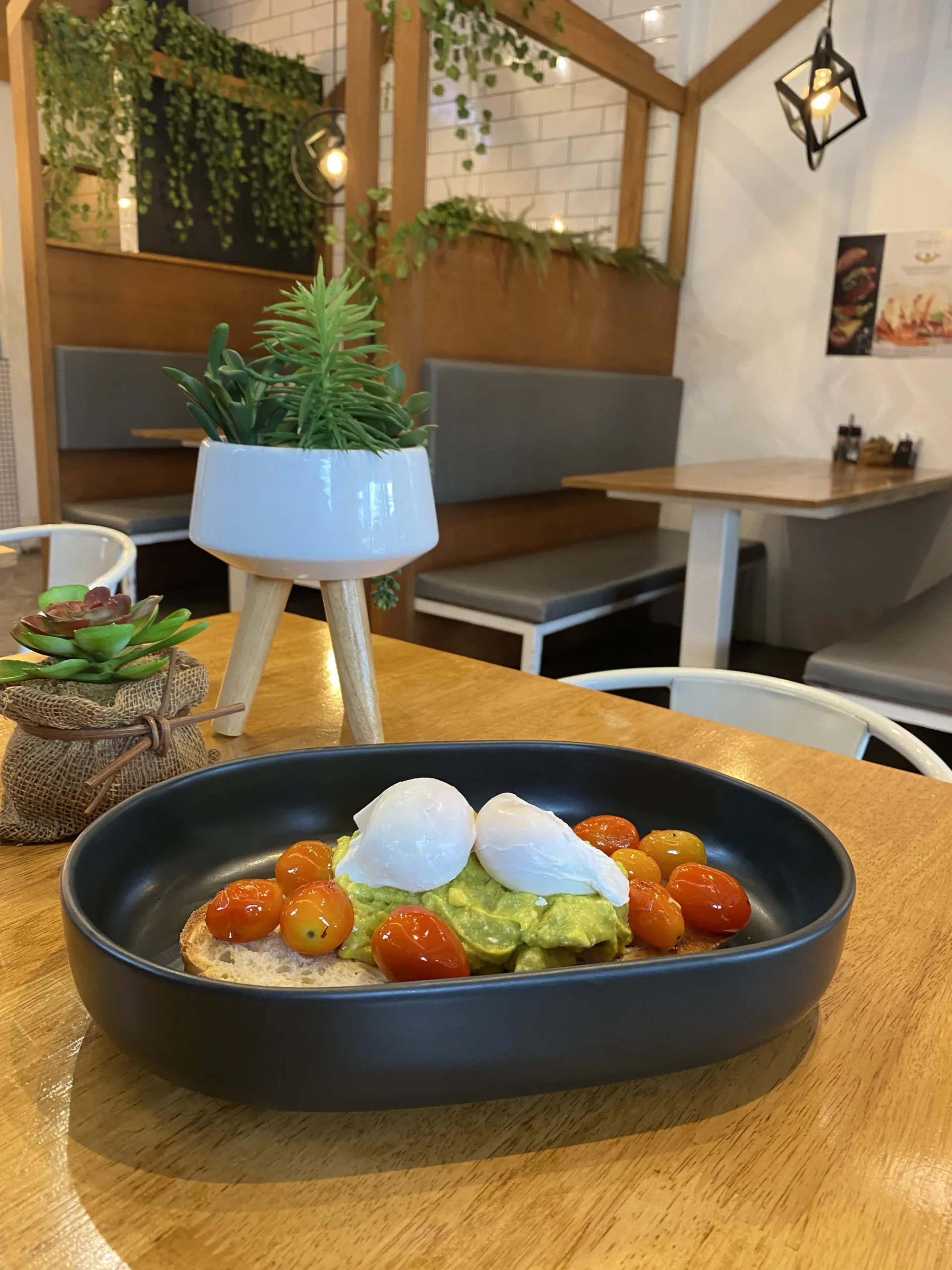 Smashed avo and roasted tomatoes on sourdough bread with creamy poached eggs at one of the best places to visit in Chalong, Poached Breakfast Cafe, Chalong, Phuket, Thailand