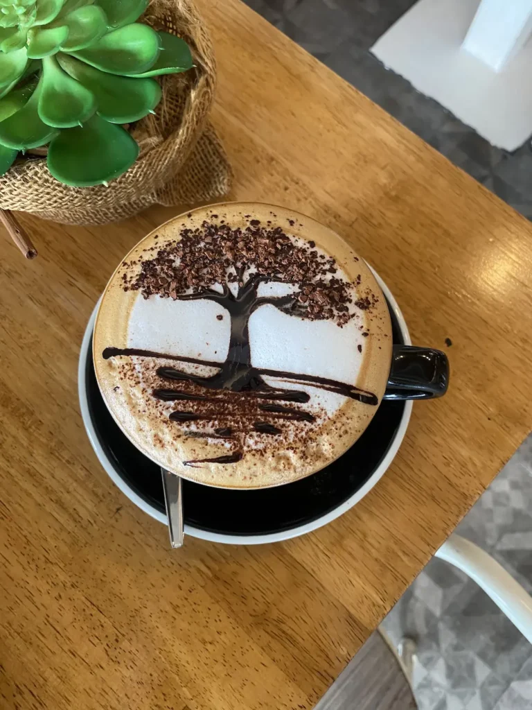 Impressive latte art of a tree on top of a mocha coffee. This is the best meal in Chalong and can only be found at Poached Breakfast Cafe, Chalong, Phuket, Thailand