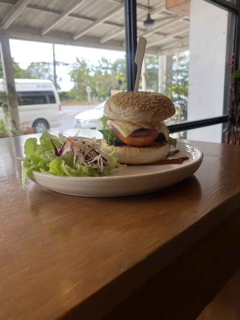 Halloumi bagel with salad on the bar next to a big window at the place with the Best Coffee Art Phuket Has to Offer: Poached Breakfast Cafe, Chalong, Phuket, Thailand