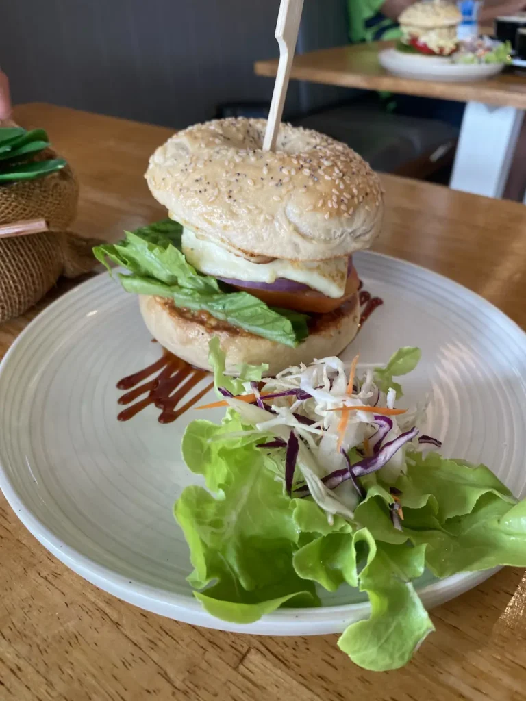 Halloumi bun with smoked bbq cream cheese and salad on a table at the best of the famous cafes in Phuket: Poached Breakfast Cafe, Chalong, Phuket, Thailand