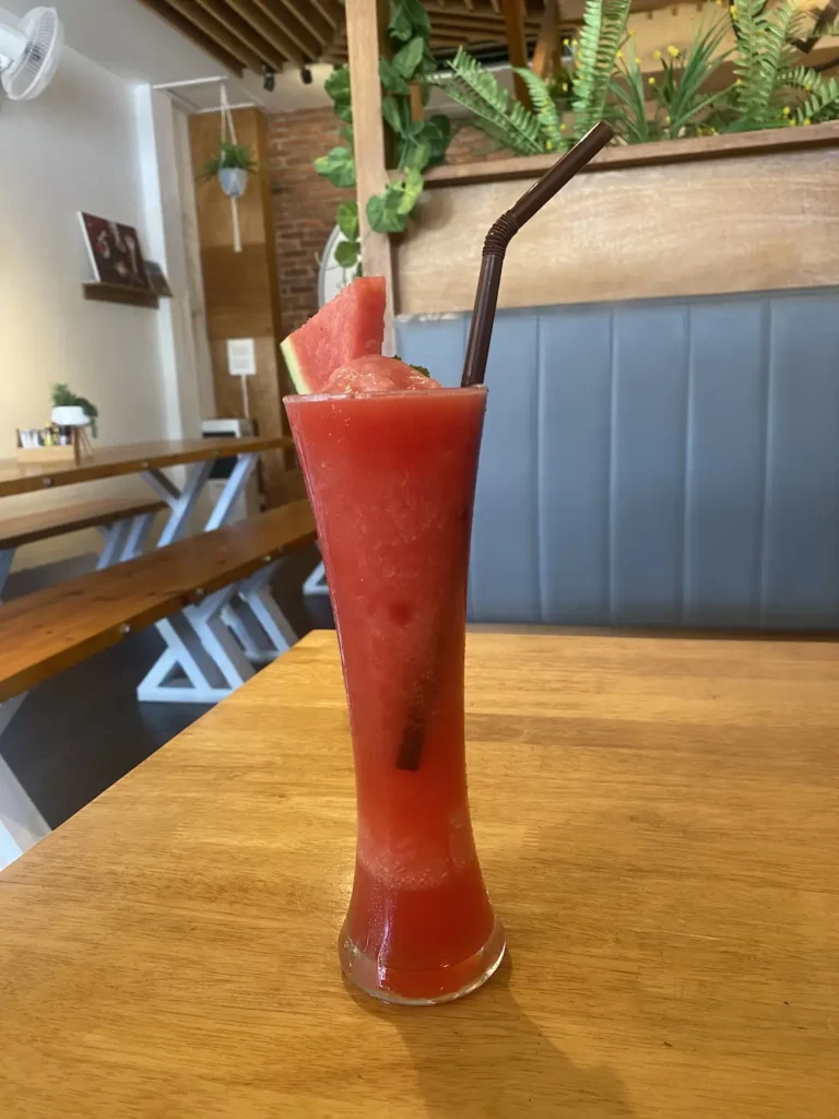 Watermelon Juice near Chalong - just sitting on a table with a slice of watermelon around the glass. Only at Poached Breakfast Cafe, Chalong, Phuket, Thailand