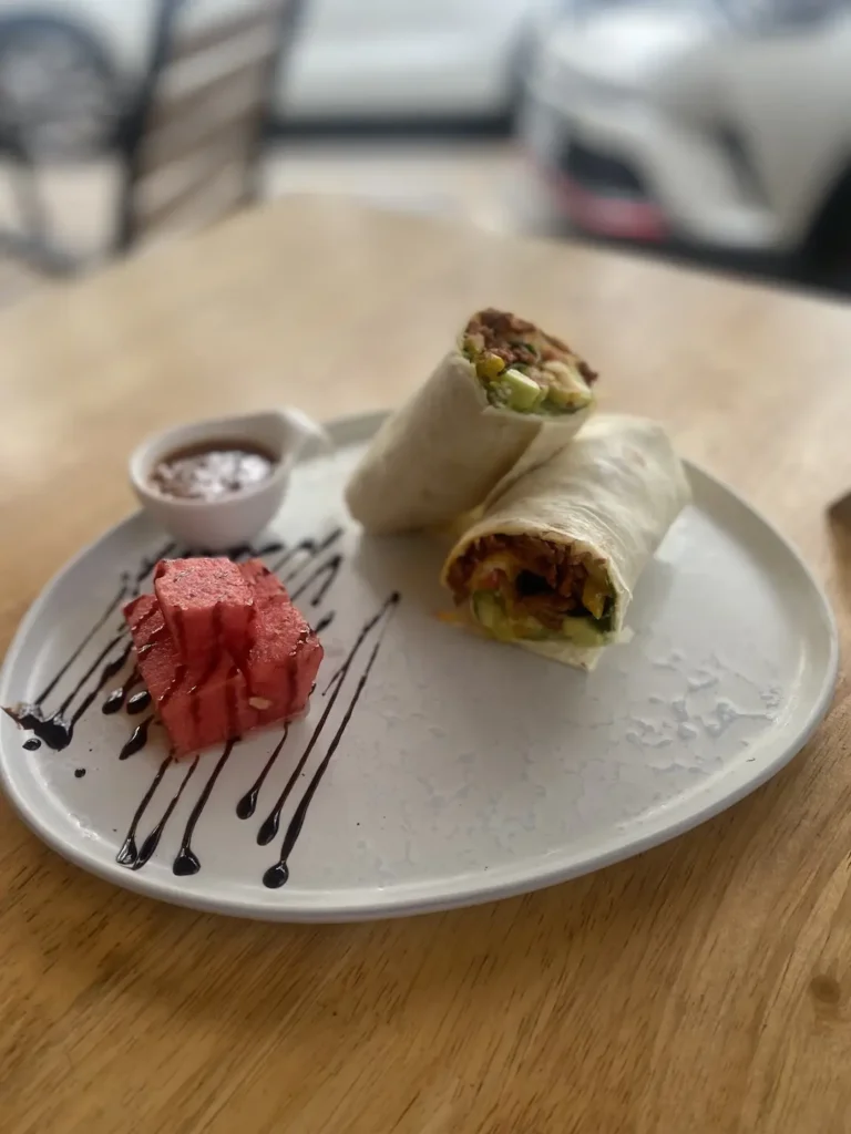 Spicy Sausage wrap with watermelon at a cafe with good coffee in Chalong at Poached Breakfast Cafe, Chalong, Phuket, Thailand